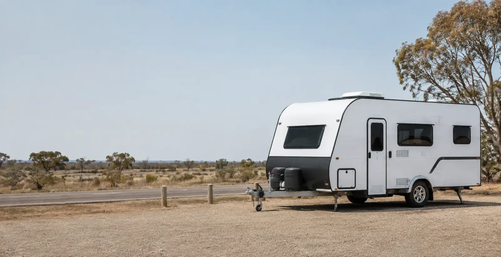 A white caravan at a quiet roadside rest area in regional Australia